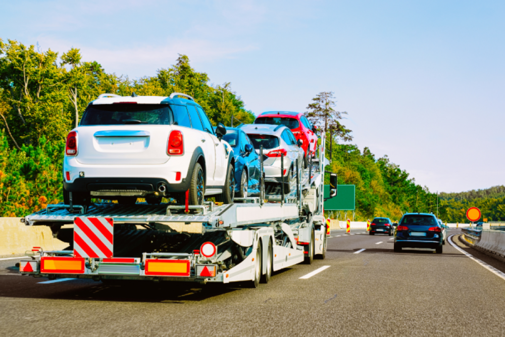 Cars being shipped on an open auto transport carrier